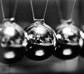 photo of newton's cradle (pendulum toy with shiny chrome balls)