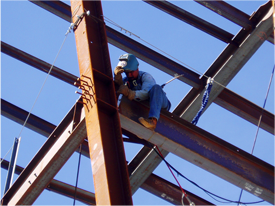 Construction worker on I beam structure