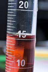Image of cylinder filled with red liquid