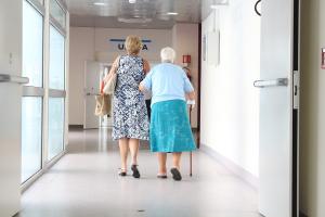 Women walking arm in arm down a hospital hallway