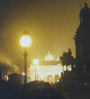 Night photo of an English street with a statue of a rider on a horse