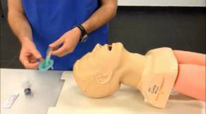 intubation practice mold of head sits on table next to practitioner