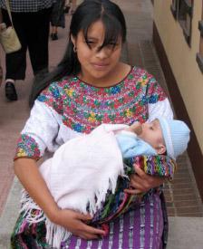 Minority mother cradling her baby