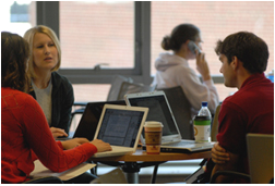 Three people chatting over laptops